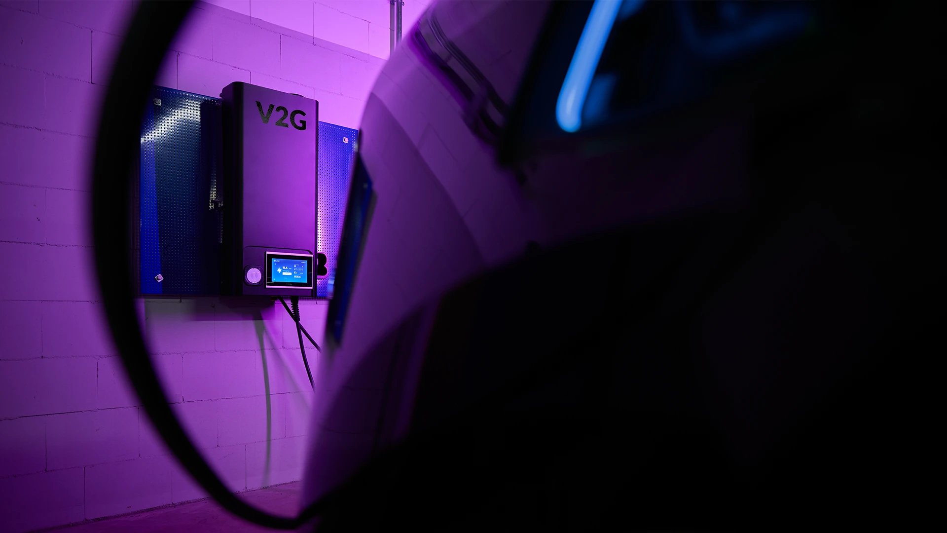 Virta press photo: Vehicle-to-grid charger car purple garage Photo: Ville Vappula