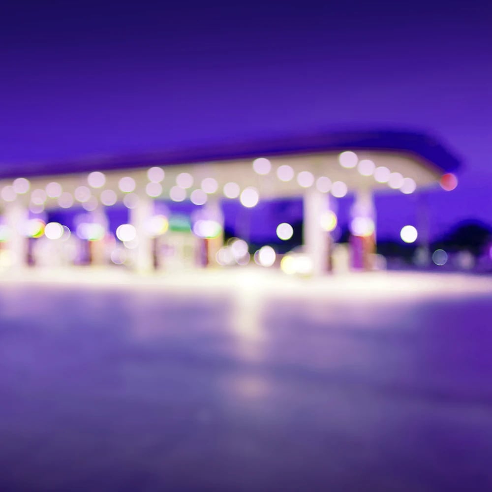 Blurred image of a petrol station in the early evening