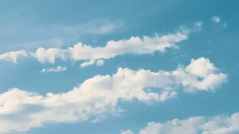Blue sky with scattered white clouds on a clear day