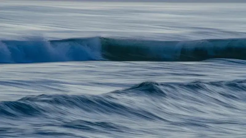 Rolling blue ocean waves captured with motion blur
