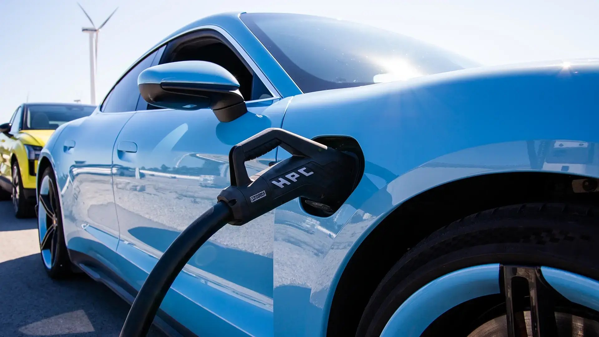 Blue EV HPC charging connector wind turbine blue sky