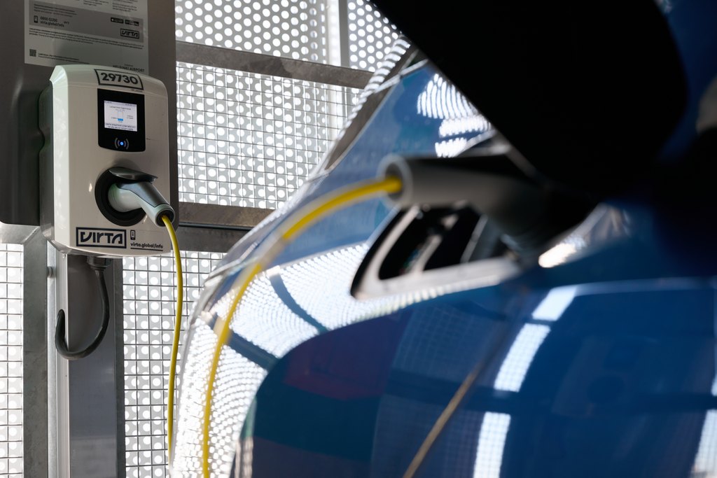 Electric vehicle at urban parking garage connected to an AC charger