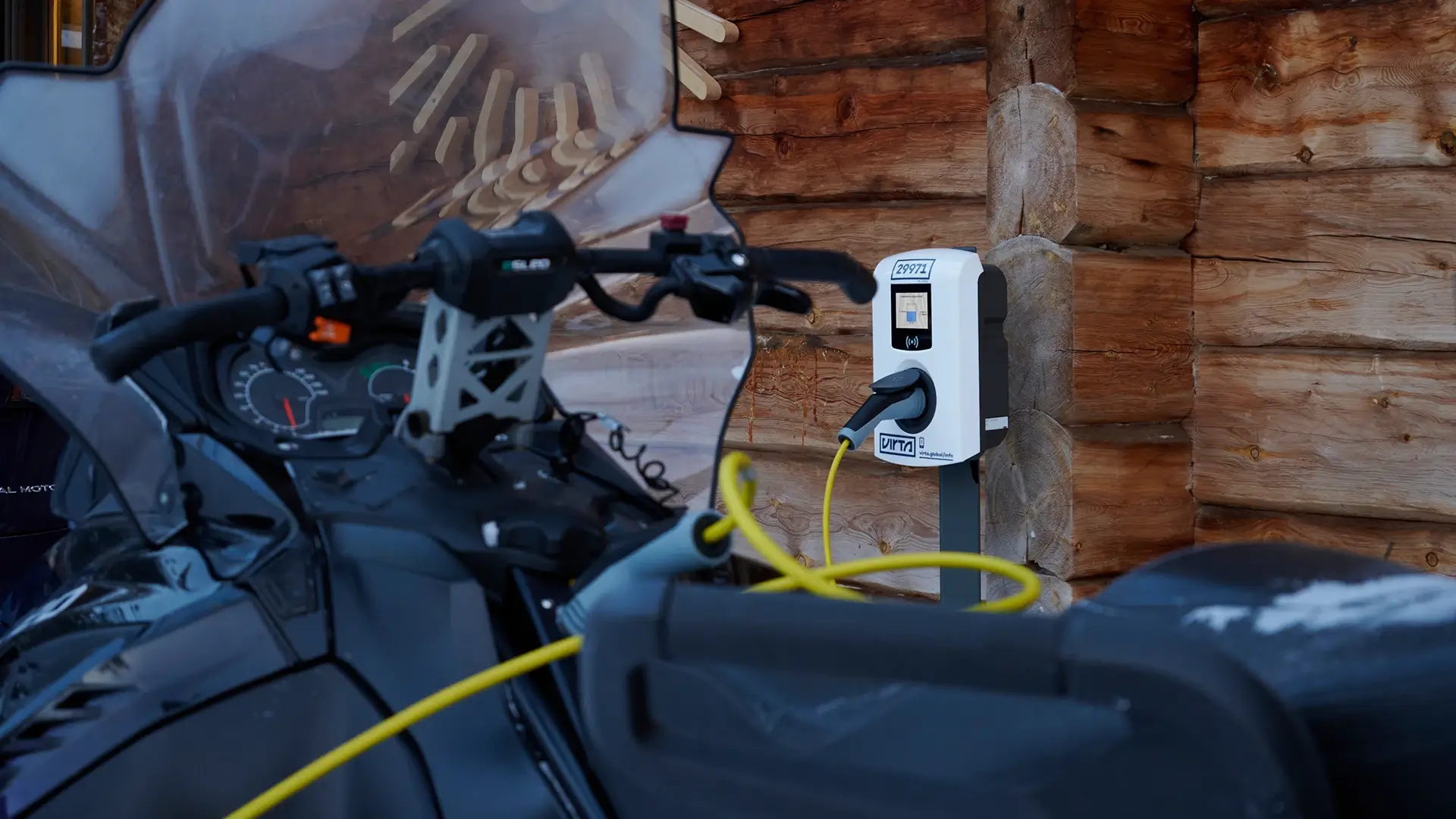 Electric snowmobile AC charging station outside cabin