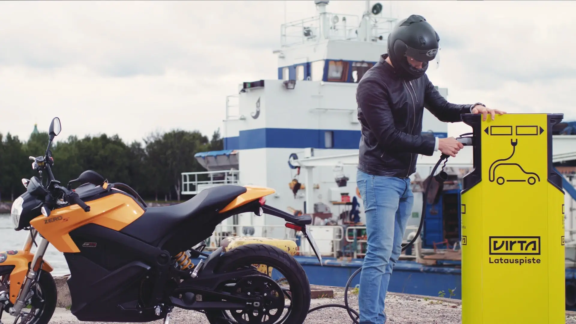 Man charging electric motorcycle harbor