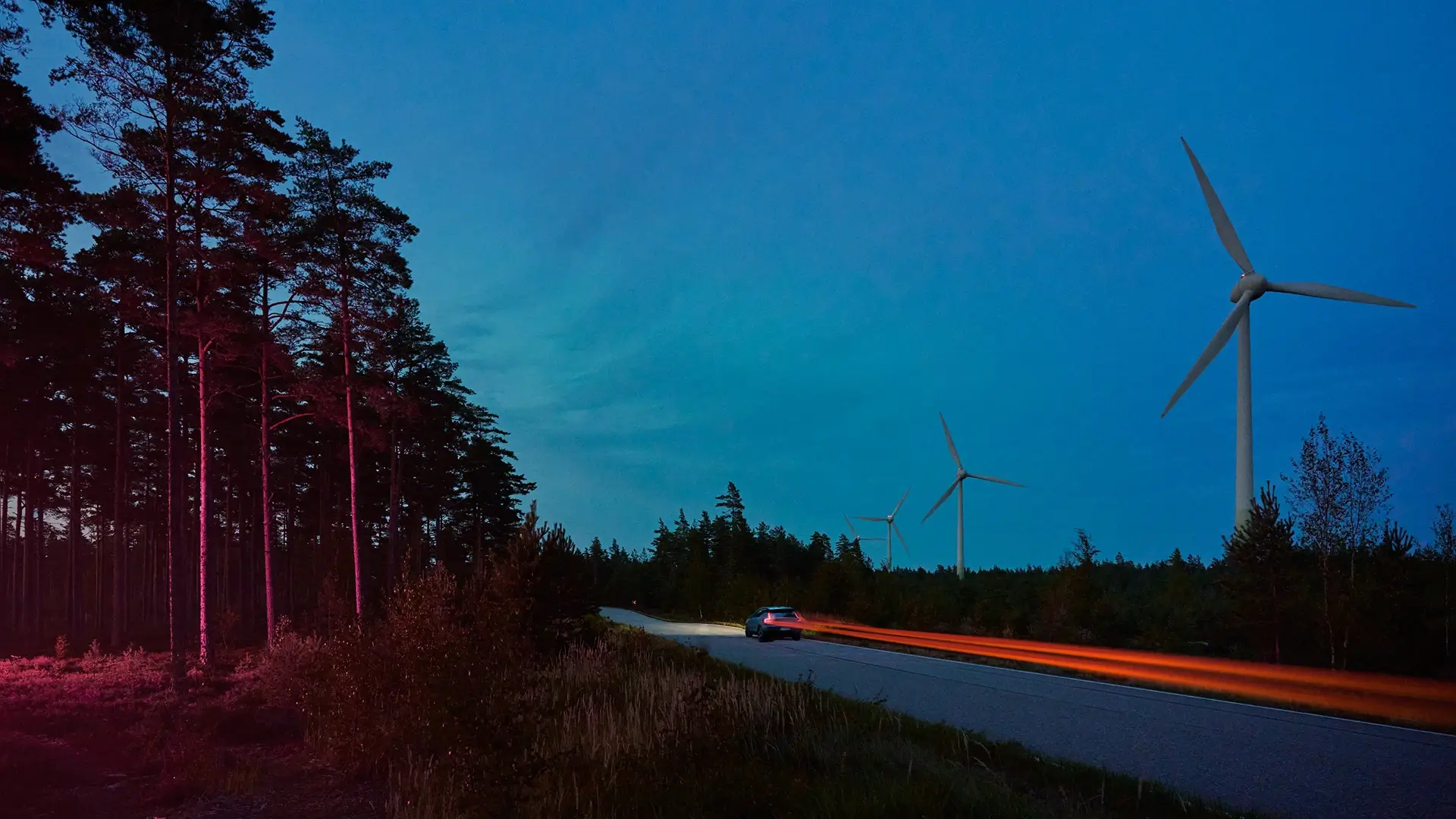 Wind turbines road night car light trails