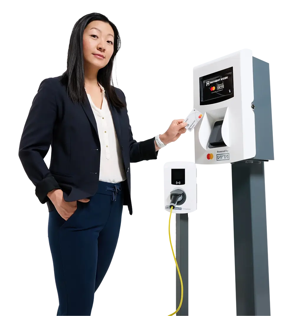 Photo of a woman standing with a payment card in her hand, ready to pay for charging in Virta Payment Kiosk